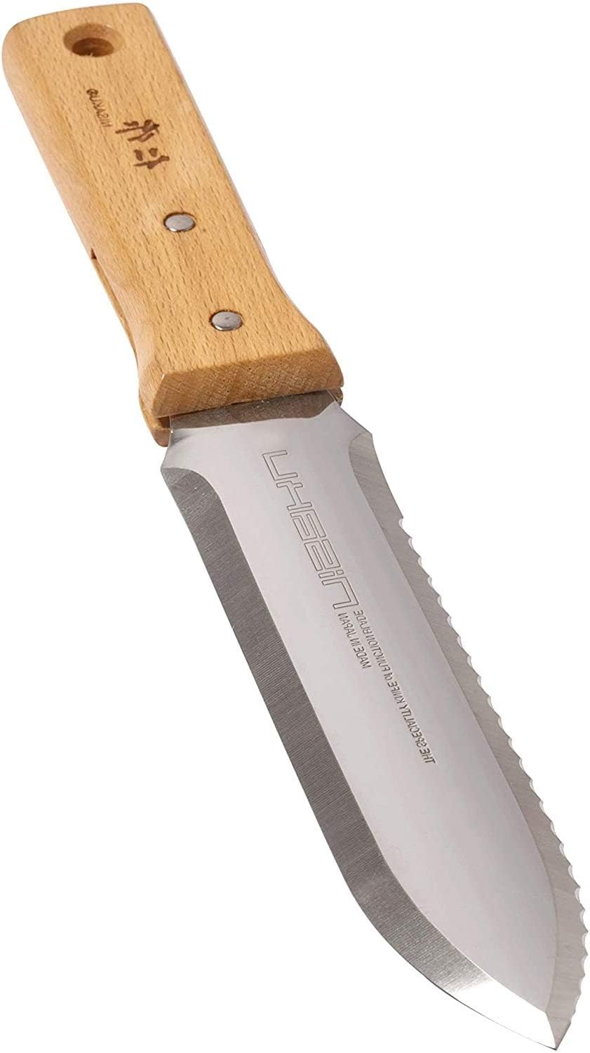 A versatile Hori Hori garden knife in the soil.